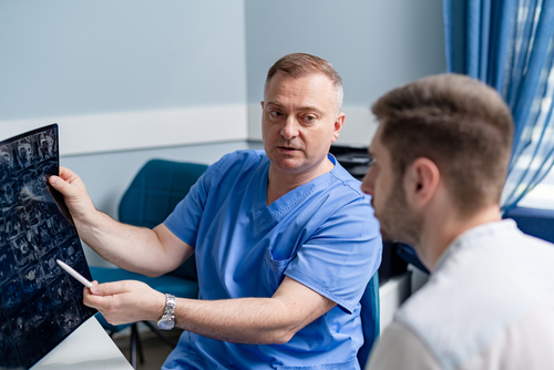 Doctor reviewing an X-ray with a patient