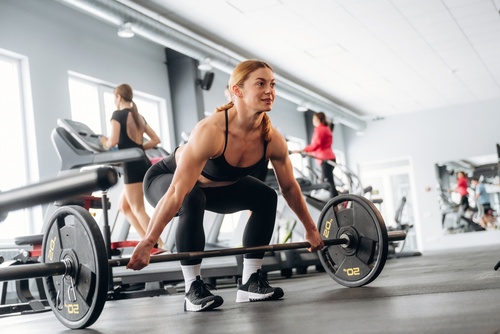 Woman lifting weights during a training session